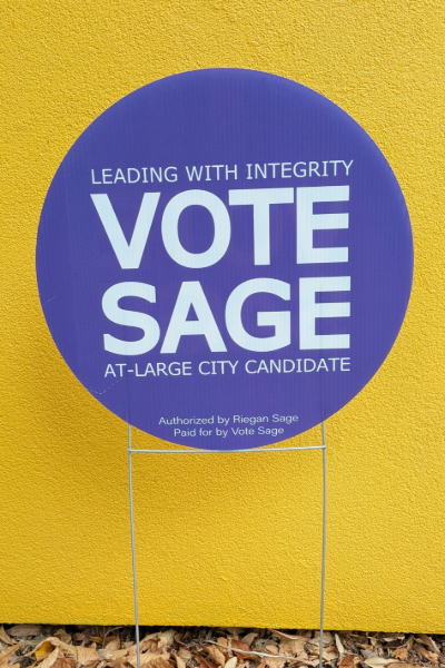 A Vote Sage yard sign in the grass.